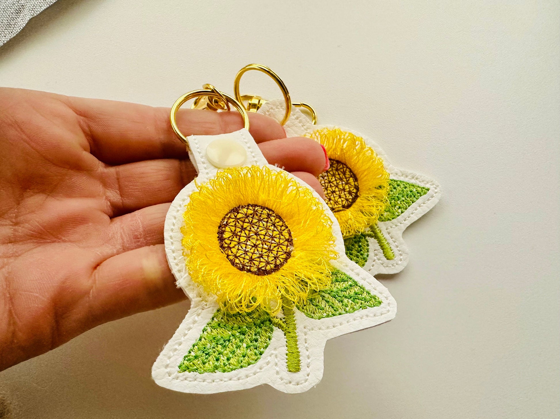 Sunflower key fob snap tab and eyelet sunflower keychain in the hoop machine embroidery designs ITH project flower fluffy fuzzy sunflower