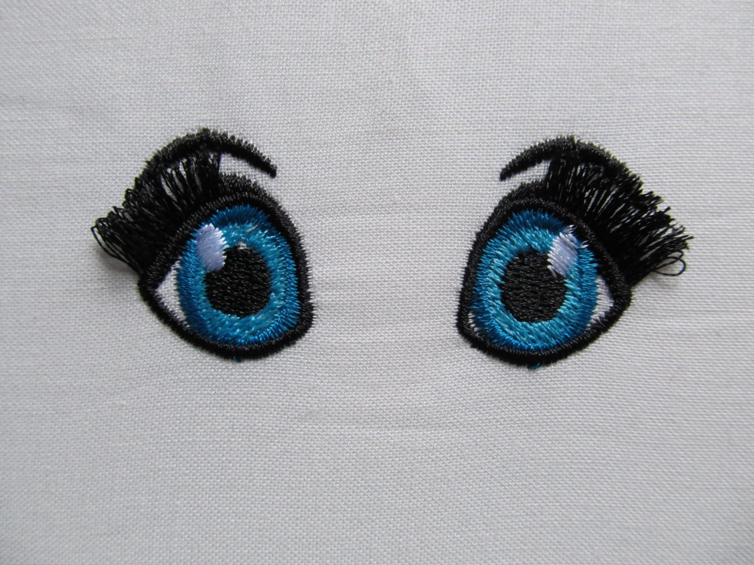 Fringed, fluffy, flare lashes dolls – Doll machine embroidery design by Artapli
