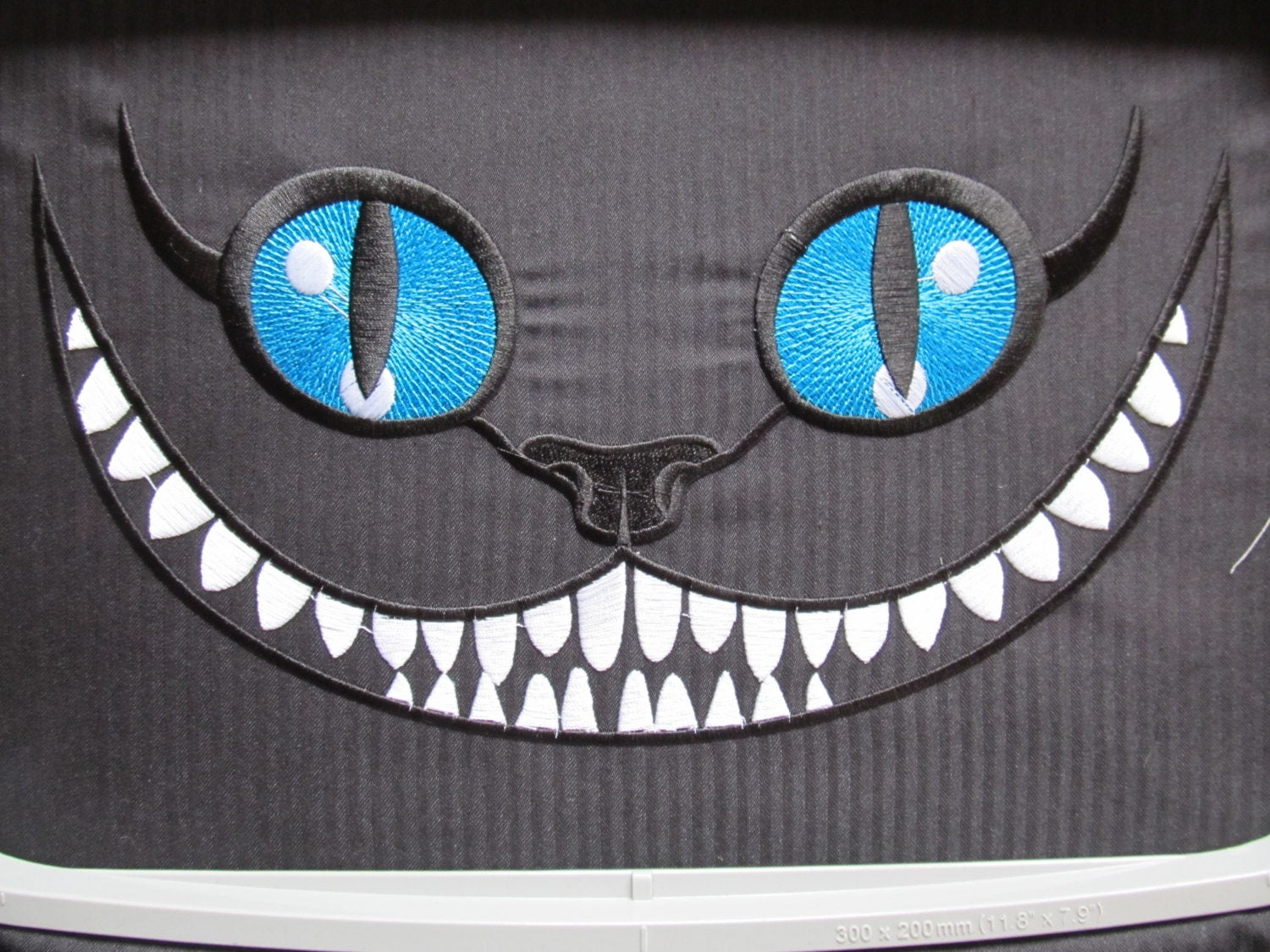 Cheshire Cat Smile – Sizes 4" 5" 6" 7" 8" 12" Digital Embroidery File | Artapli